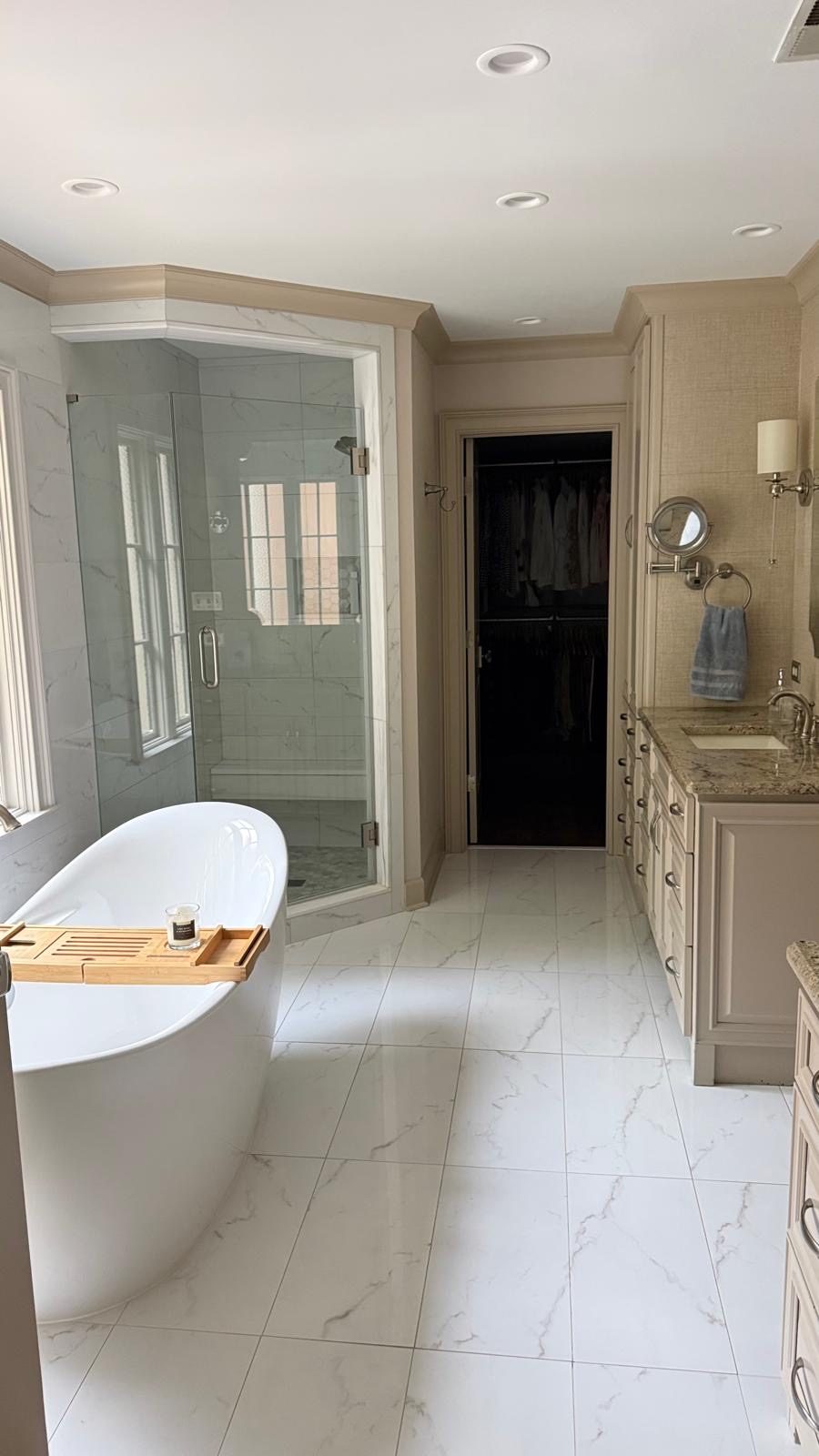 Primary bathroom with freestanding tub and glass-enclosed shower